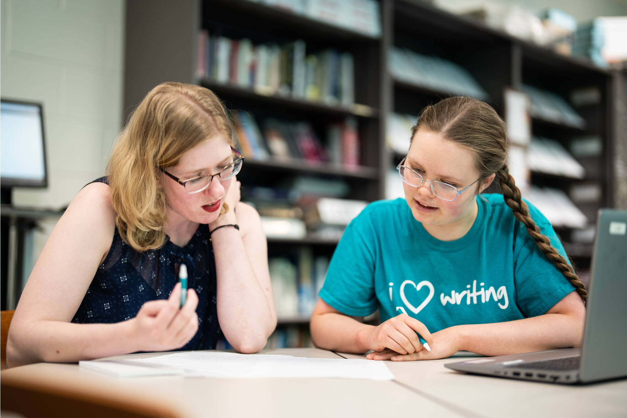 A student and a writing consultant working together